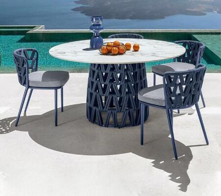 Outdoor table and chair made with weather resistant UV resistant rattan/rope and aluminum frame built for gardens courtyards and villas