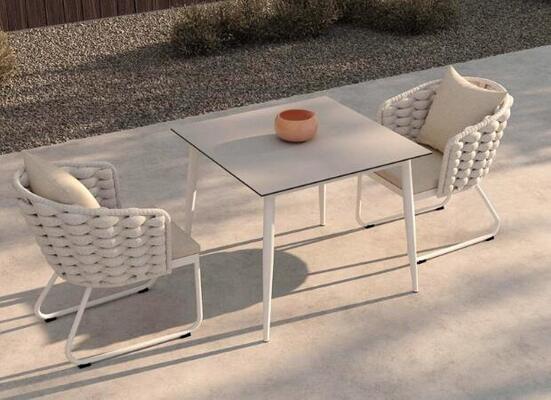 Outdoor table and 6pcs chairs crafted from weather resistant UV rope and aluminum frame perfect for in gardens courtyards and villa outdoor spaces